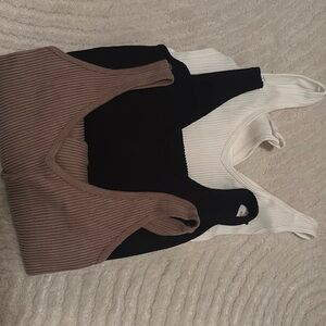 White, black, and brown body suits